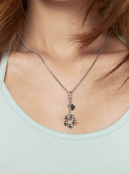 Daisy Petal Necklace IL517 Silver front model neck shot styled over mint green scoop-neck top with curb chain and flower bead pendant
