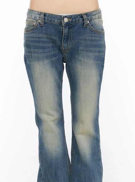 Dawn Low Rise Bootcut Jeans CU530 Blue close-up front detail shot on model showing low-rise waistband, button fly, front pockets and vintage wash fading