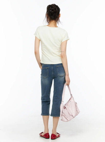 Deena Washed Capri Jeans CU530 blue denim back full-length shot on model styled with cream tee and pink shoulder bag showing back pocket detail