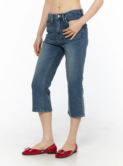 Deena Washed Capri Jeans CU530 blue denim side shot on model from waist down showing slight flare hem and mid-rise fit with red flats