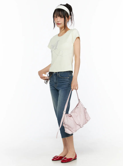 Deena Washed Capri Jeans CU530 blue denim side full-length shot on model holding pink bag styled with cream crop tee and red patent flats