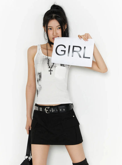 LEWKIN Dirty Wash Chest Pocket Tank Top IL509 White S/M front shot on model holding GIRL sign styled with black mini skirt and studded belt