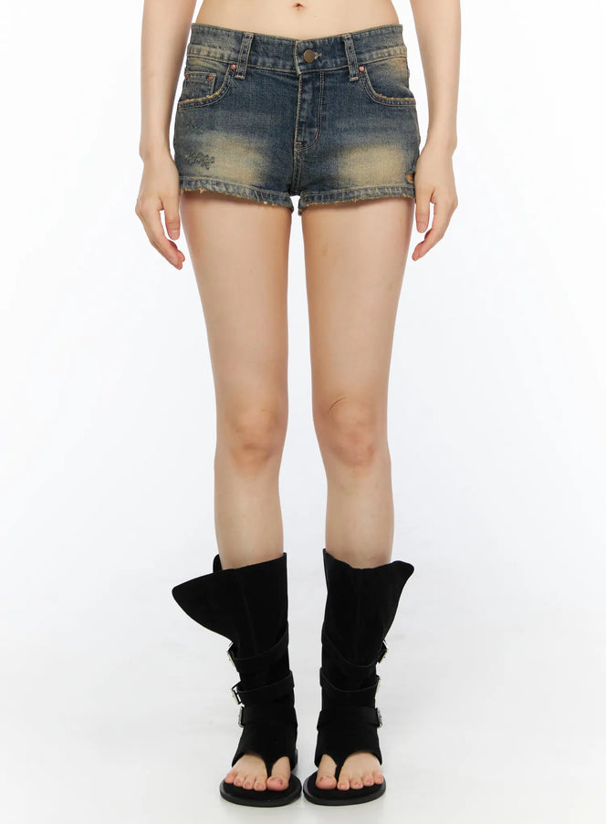LEWKIN Distressed Low-Rise Denim Shorts CU530 Dark blue front shot on model wearing black boots, low-rise micro denim with faded wash