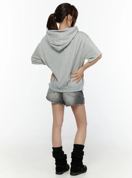 Distressed Mini Denim Shorts CL507 Black back full-body styling shot on model in gray hoodie facing away, showing back pocket and cutoff hem