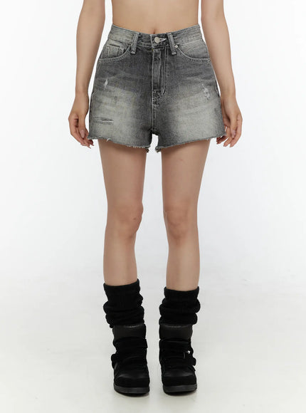 LEWKIN Distressed Mini Denim Shorts CL507 Black front view on model wearing black leg warmers and sneakers, high-waist washed denim with raw frayed hem