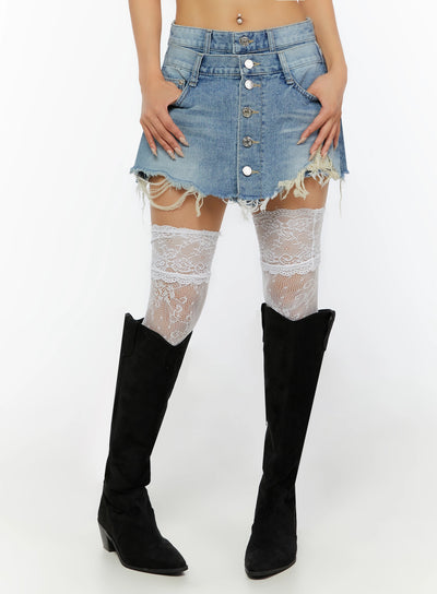 LEWKIN Distressed Mini Denim Skirt IL524 Blue Size S front close-up on model showing button-fly detail and frayed hem with white lace thigh-high socks and black boots
