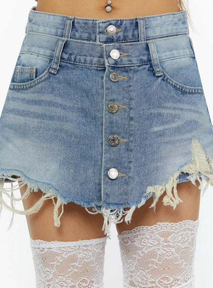 Distressed Mini Denim Skirt IL524 Blue close-up front detail showing silver button-fly closure, frayed raw hem, and washed denim texture with white lace socks below