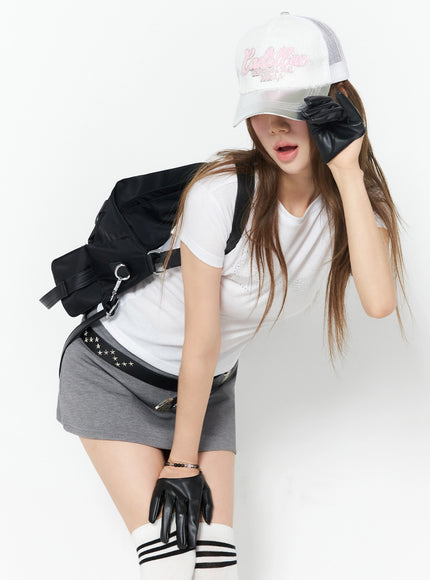 LEWKIN Diva Short Sleeve Tee IU525 White S/M front view on model wearing cap, black leather gloves, gray mini skirt, styled with backpack and knee-high socks