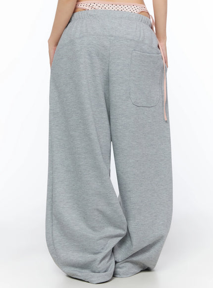 Dot Print Sagging Sweatpants IL515 Gray back cropped shot on model showing single back patch pocket pink side tie and voluminous pooling hem in heathered cotton