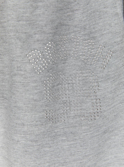 Dot Print Sagging Sweatpants IL515 Gray close-up of silver studded rhinestone logo lettering on heathered gray cotton fabric thigh