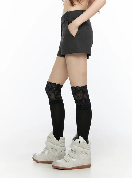 Double Button Low-Rise Shorts CL523 Dark gray side shot model hand in pocket showing side seam and low-rise waistband with lace socks and wedge sneakers