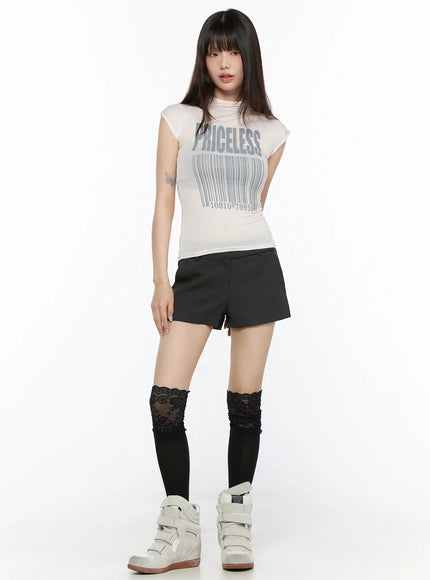 Double Button Low-Rise Shorts CL523 Dark gray full-body front shot model in graphic tee and dark gray low-rise mini shorts with lace socks and white sneakers