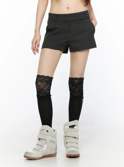Double Button Low-Rise Shorts CL523 Dark gray front shot model wearing low-rise tailored shorts with double button closure lace knee-high socks and white wedge sneakers