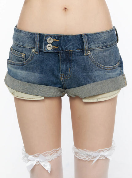 Double Button Roll-Up Denim Shorts CL523 Blue detail close-up front on model highlighting double metal buttons, orange contrast stitching, washed blue denim, and rolled cuffs