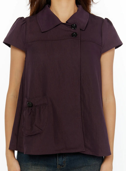 Double-Button Short Sleeve Blouse CL515 dark purple close-up front detail showing asymmetric double-button collar ruched pocket and cap sleeve