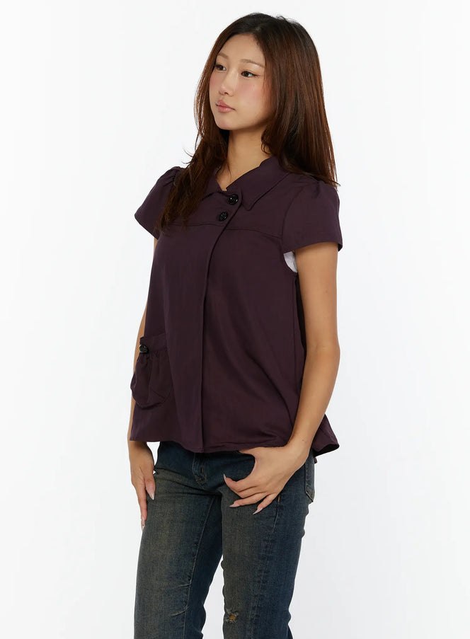 Double-Button Short Sleeve Blouse CL515 dark purple side view model standing showing flared silhouette button-accent pocket and puff cap sleeves