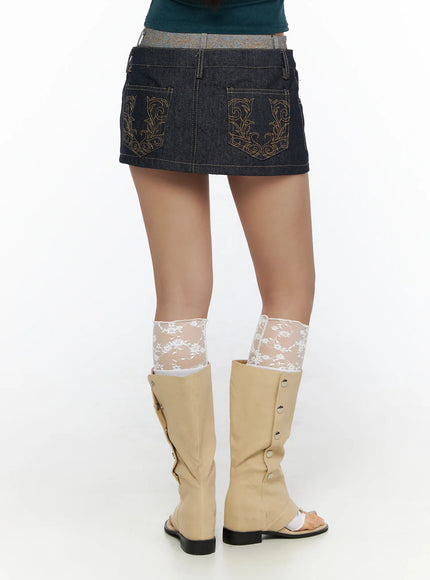 Double-Layered Back Embroidered Denim Mini Skirt CL513 dark indigo back lower-body shot model showing gold baroque embroidered pockets and back skirt hemline