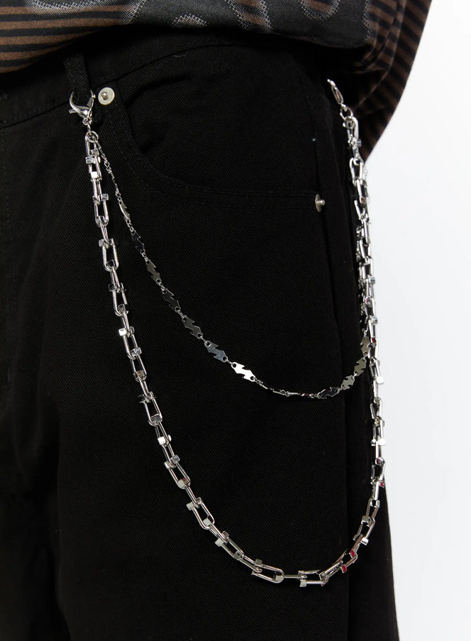 LEWKIN Double-Layered Chain IL509 silver close-up detail on model wearing black pants, showing layered link and lightning bolt chain clipped to waistband