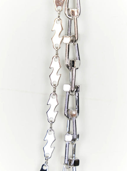 Double-Layered Chain IL509 silver close-up flat detail showing rectangular link chain and jagged lightning bolt chain with polished metal finish
