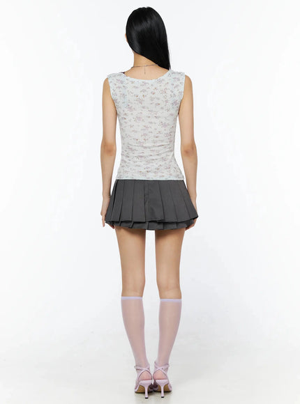 Double Pleated Mini Skirt IL509 Dark gray back full-body view on model in floral tank top, double-tiered pleated skirt, lavender socks and pink heeled sandals