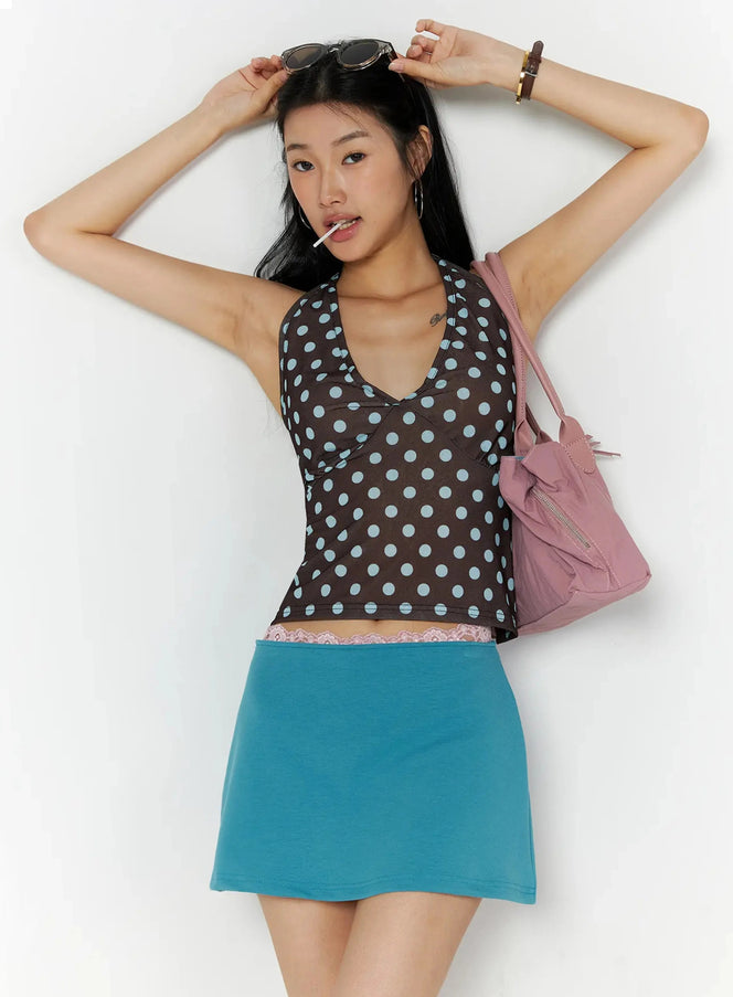 Double Pocket Shoulder Bag IL516 Pink styled on female model front view carrying bag on shoulder over polka dot halter top and teal mini skirt