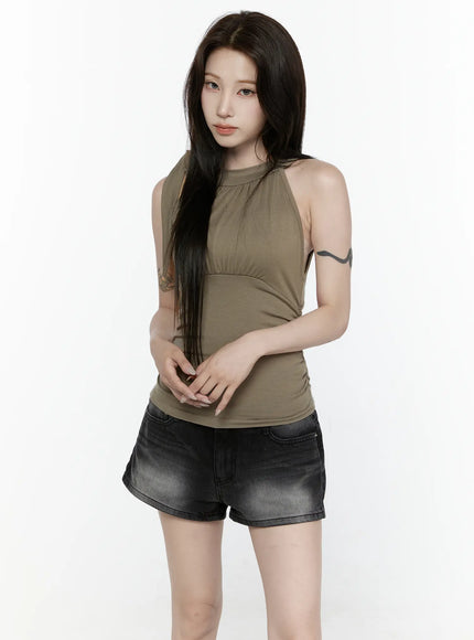 Draped Halter Tank Top IL522 Dark green front model standing hands clasped at waist showing gathered bust seam and fitted silhouette with denim shorts