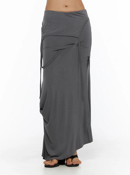 Draped Maxi Skirt CL503 Dark gray front close-up on model showing folded waistband, curved pocket detail, and side tie strings