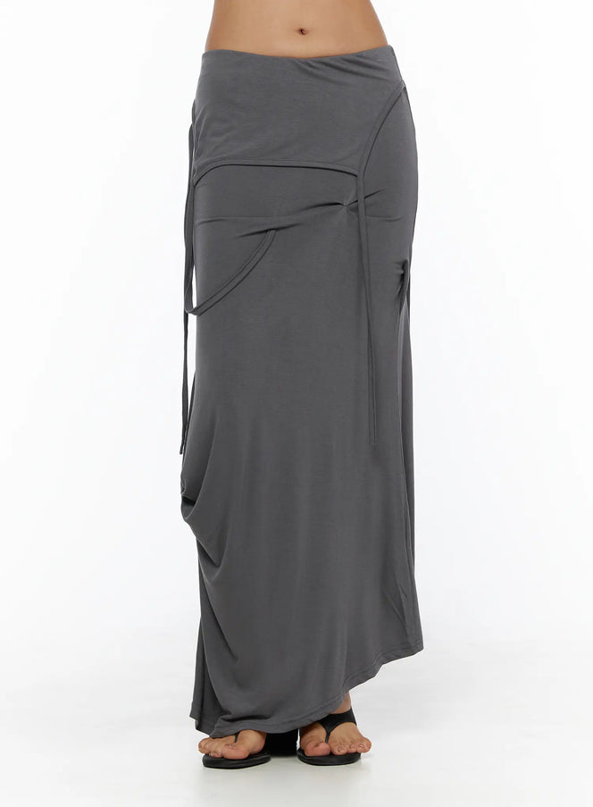 Draped Maxi Skirt CL503 Dark gray front close-up on model showing folded waistband, curved pocket detail, and side tie strings