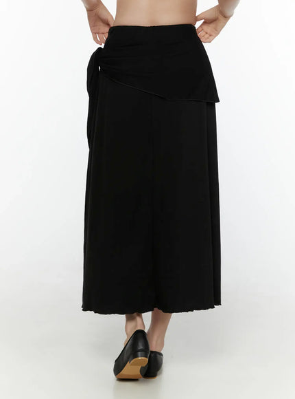 Draped Wrap Maxi Skirt CL520 Black back shot on model showing rear waistband ruching, side tie detail, and flared maxi hem