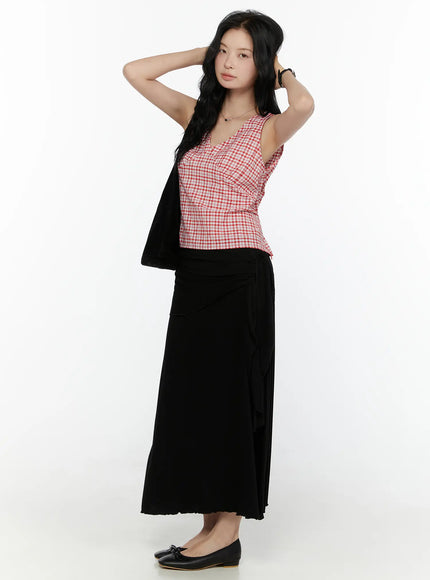 Draped Wrap Maxi Skirt CL520 Black three-quarter front shot on model with hand in hair, styled with red gingham top and cardigan