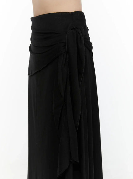 Draped Wrap Maxi Skirt CL520 Black side close-up detail showing ruched waistband, tie strings, and layered wrap panel texture