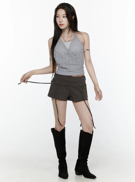 Drawstring Banded Shorts IL522 Dark gray full-body front view on model in gray lace halter top and black cowboy boots, holding dangling strap outward