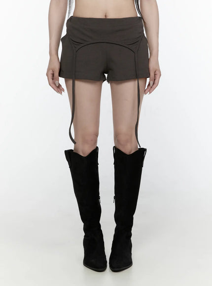 LEWKIN Drawstring Banded Shorts IL522 Dark gray front view on model wearing black knee-high boots, low-rise waistband with curved seam detail and hanging straps