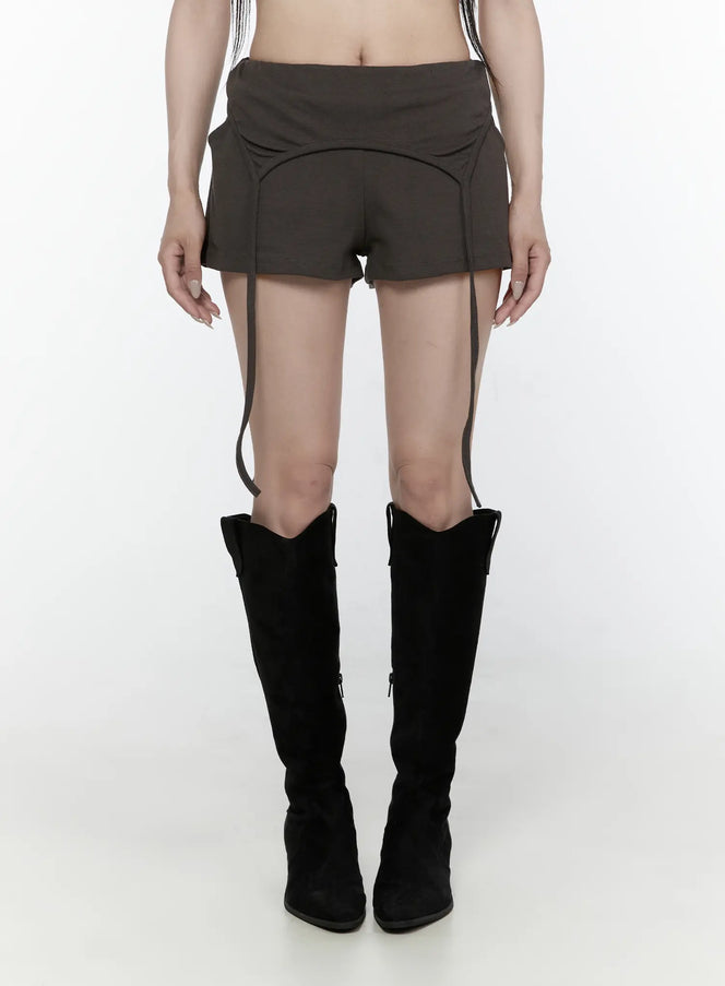 LEWKIN Drawstring Banded Shorts IL522 Dark gray front view on model wearing black knee-high boots, low-rise waistband with curved seam detail and hanging straps