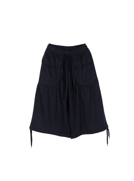 Drawstring Bermuda Shorts CL513 Navy flat-lay front view showing elastic drawstring waistband, dual button flap pockets, wide gathered legs, and side hem drawstring ties