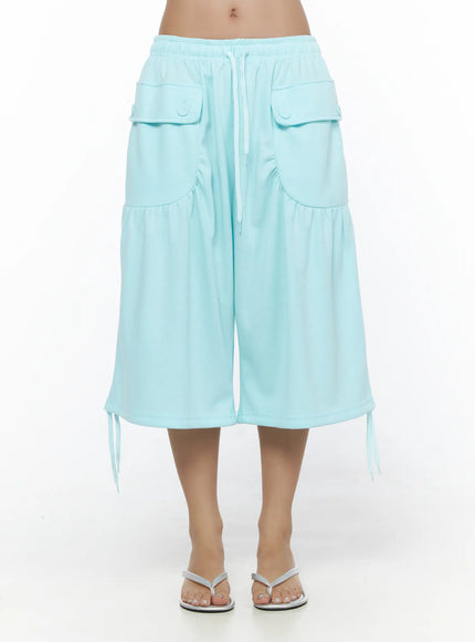 Drawstring Bermuda Shorts CL513 Mint front shot on model standing straight showing flap cargo pockets, white drawstring waist, wide-leg silhouette, and hem tie detail