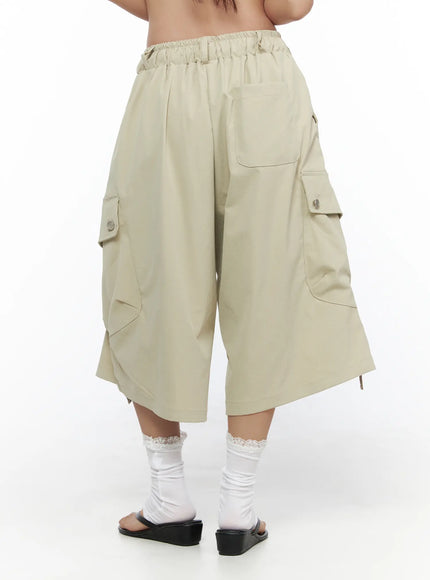 Drawstring Cargo Jorts CL510 Beige back shot on model without styling showing elastic waistband, back patch pocket, and bilateral cargo flap pockets