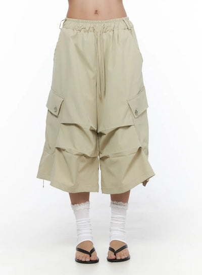 LEWKIN Drawstring Cargo Jorts CL510 Beige front close-up on model showing elastic drawstring waistband and layered wide-leg silhouette with snap-button cargo pockets