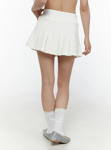 Drawstring Pleated Mini Skirt CL507 White back shot on model showing smooth waistband and pleated hem, styled with lace socks and grey ballet flats