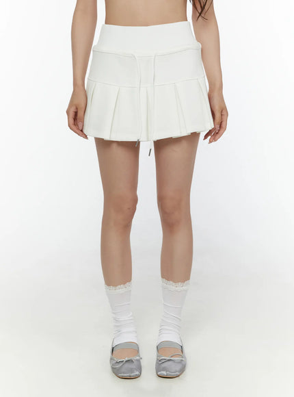 Drawstring Pleated Mini Skirt CL507 White front full-length shot on model showing pleated mini silhouette with silver drawstring hardware and lace trim socks