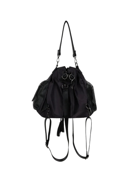 Drawstring Pocket Bucket Bag IL515 Black front product shot showing drawstring opening, nylon body, pebbled leather zip pockets, tassel, and detached backpack straps