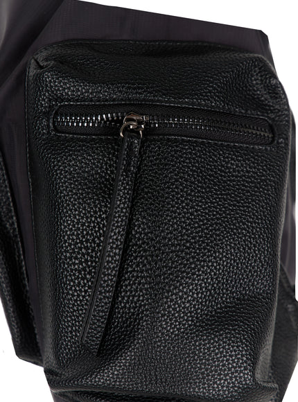 Drawstring Pocket Bucket Bag IL515 Black close-up detail of pebbled faux leather side zip pocket with gunmetal zipper pull and pebble grain texture