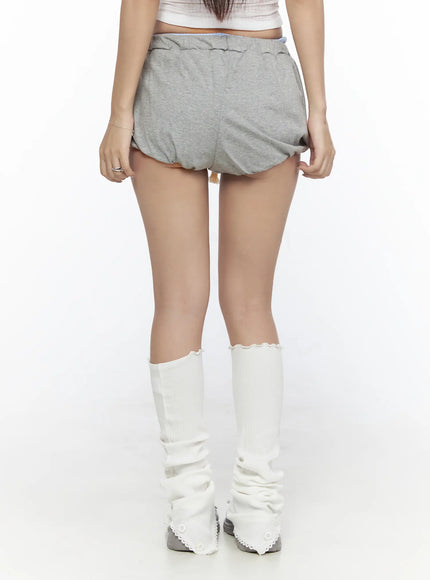 Drawstring Sweat Shorts CL527 Gray back close-up shot on model showing rounded bubble hem, elastic waistband, and blue lining detail