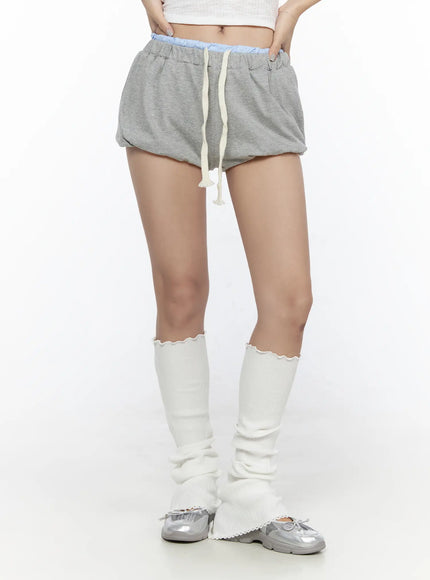 Drawstring Sweat Shorts CL527 Gray front shot on model showing balloon-fit shorts with cream drawstring, blue waistband, styled with white leg warmers and silver shoes