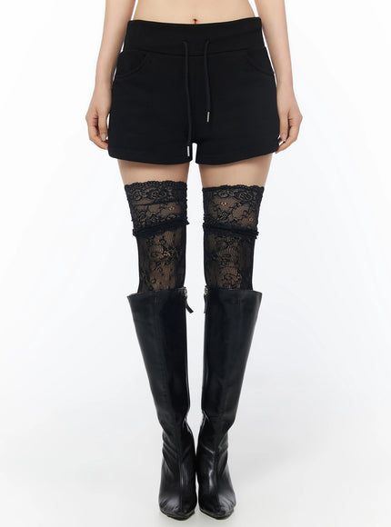 LEWKIN Drawstring Sweat Shorts IL502 Black S/M front shot on model wearing lace thigh-high socks and black knee-high boots, cropped view