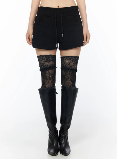 LEWKIN Drawstring Sweat Shorts IL502 Black S/M front shot on model wearing lace thigh-high socks and black knee-high boots, cropped view