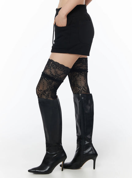 Drawstring Sweat Shorts IL502 Black side waist-down shot on model showing side pocket, drawstring detail and floral lace thigh-high socks