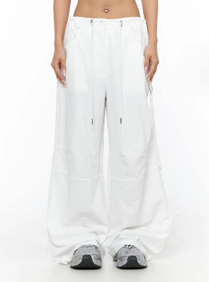 LEWKIN Drawstring Wide Leg Parachute Pants CU524 White front view on model cropped at waist showing silver zip hardware and drawstring detail size M/L