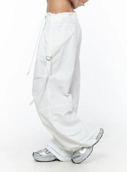 Drawstring Wide Leg Parachute Pants CU524 White side view on model showing D-ring strap hardware wide leg silhouette and nylon texture with silver sneakers