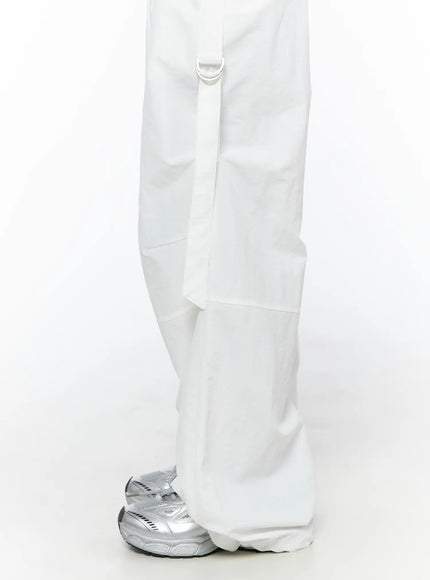 Drawstring Wide Leg Parachute Pants CU524 White close-up side detail of D-ring strap panel seam and wide leg hem pooling over silver sneakers